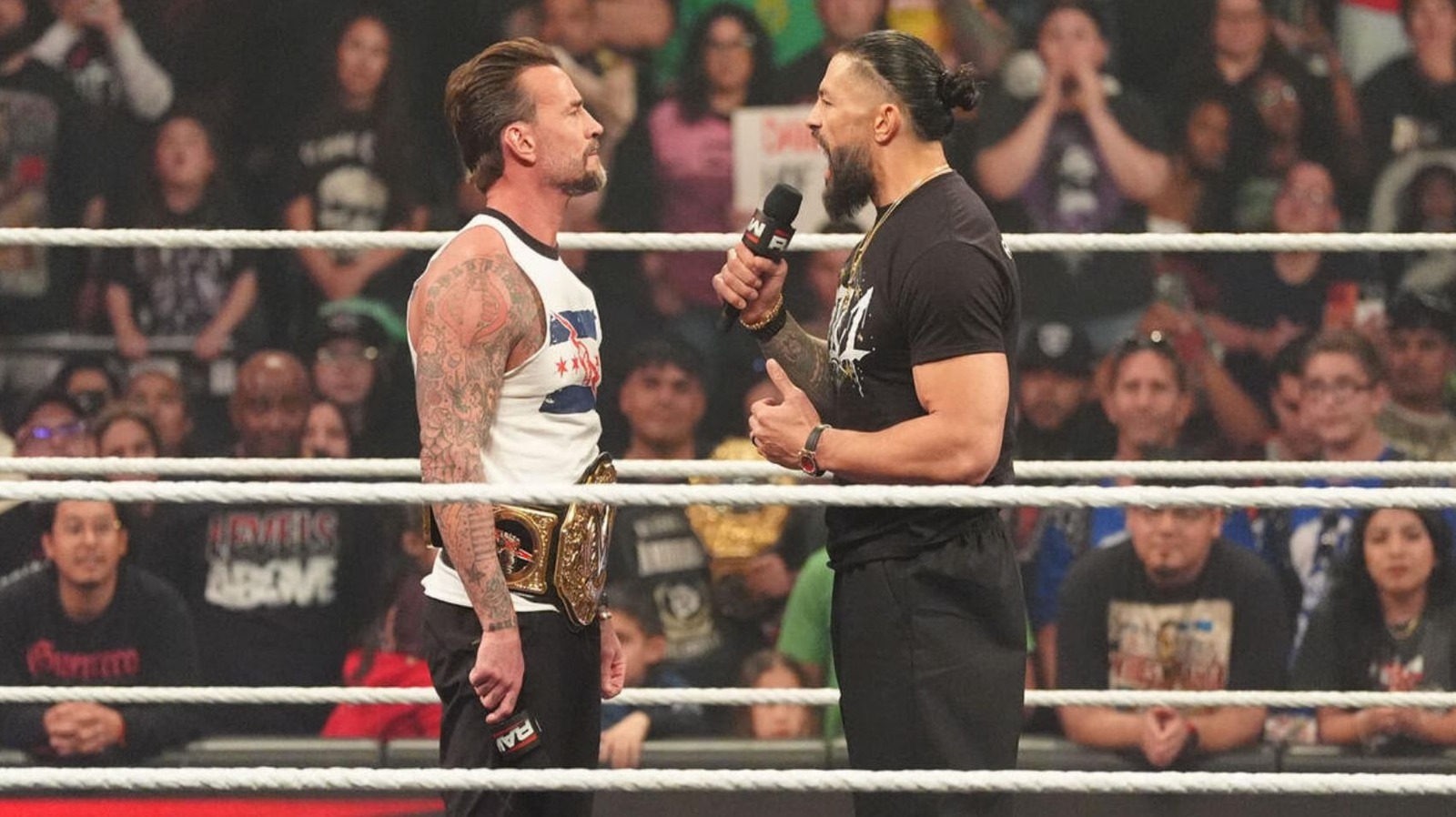 Roman Reigns Puts CM Punk Through Table After WWE Raw Confrontation Involving The Usos